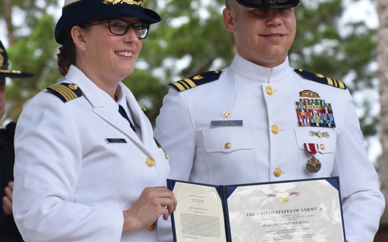 Capt. Kristen Serumgard, chief of the U.S. Coast Guard Atlantic Area Operational Forces, honors Lt. Cmdr. Mark Ketchum, who led the Maritime Safety and Security Team Kings Bay.