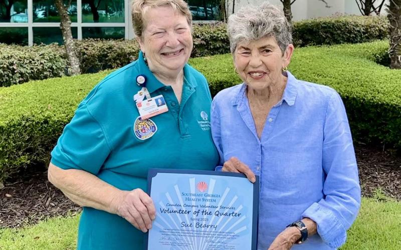 Camden County Volunteer Services President Kathleen Worthing, left, presents Sue Bearry with the Camden Campus Spring Volunteer of the Quarter award.