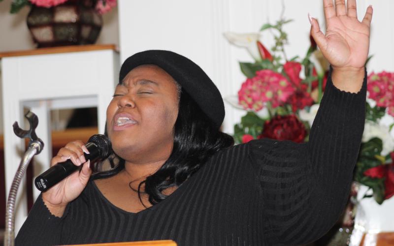 Minga Williams sings Monday during the Martin Luther King Jr. March and Unity Program celebration Monday in Kingsland.