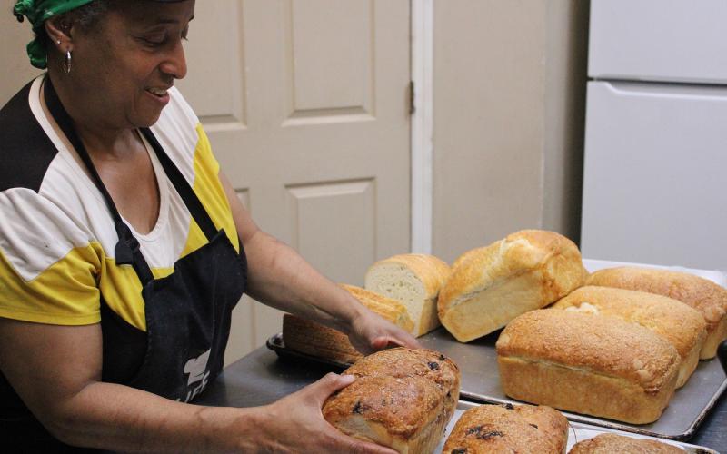 Spouses Bakery and Deli owner Vanessa Logan shows off loaves of sourdough bread.