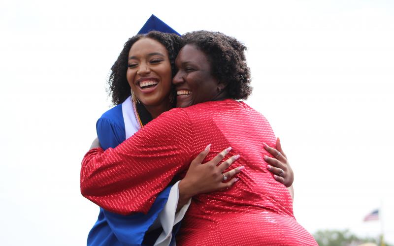 Fernandina Beach High School’s Kamryn Williams, left, is all smiles as she hugs her mother, teacher Keisha Williams, after receiving her diploma Monday morning.