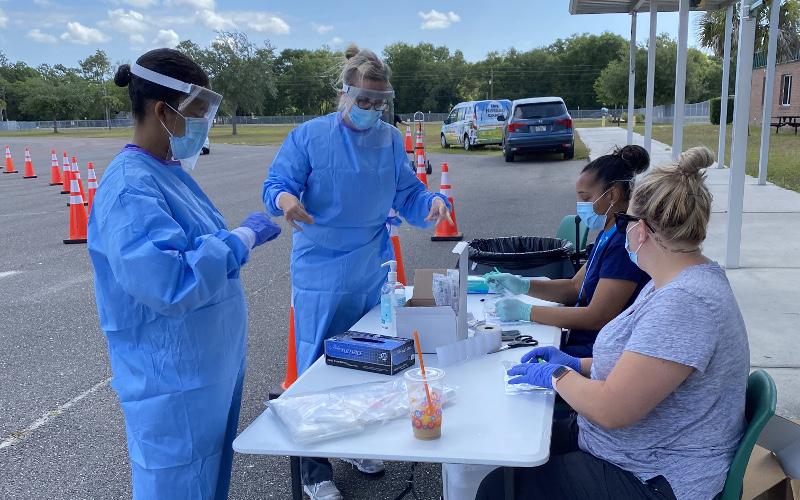 Florida Department of Health – Nassau County workers tested residents at a drive-thru COVID-19 testing site in May. JULIA ROBERTS/NEWS-LEADER