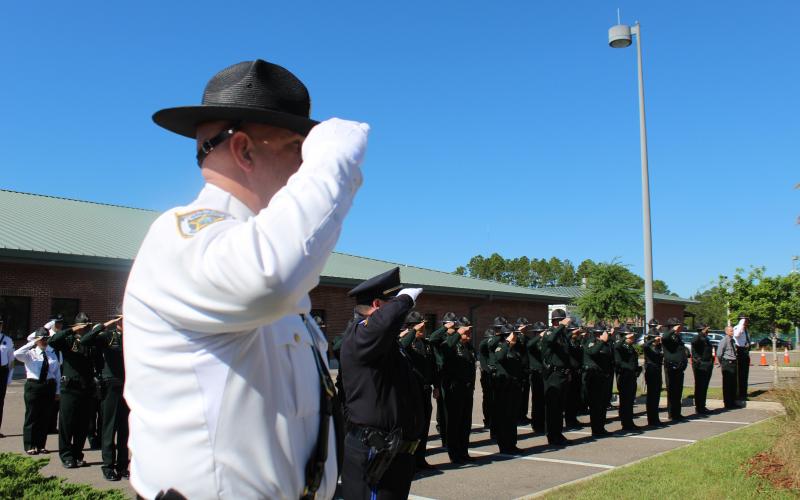 Nassau County law enforcement officers salute the fallen heroes at Nassau County Law Enforcement Memorial Plaza.