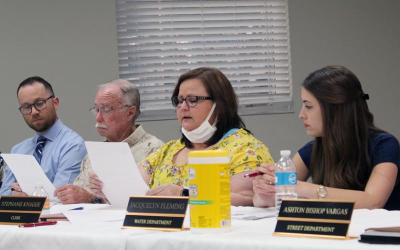 Town Clerk Stephanie Knagge reads her letter of resignation aloud Monday evening. Her resignation is effective March 31. Town Council President Ken Bass reads along in the background as interim Town Attorney Christian Waugh listens.