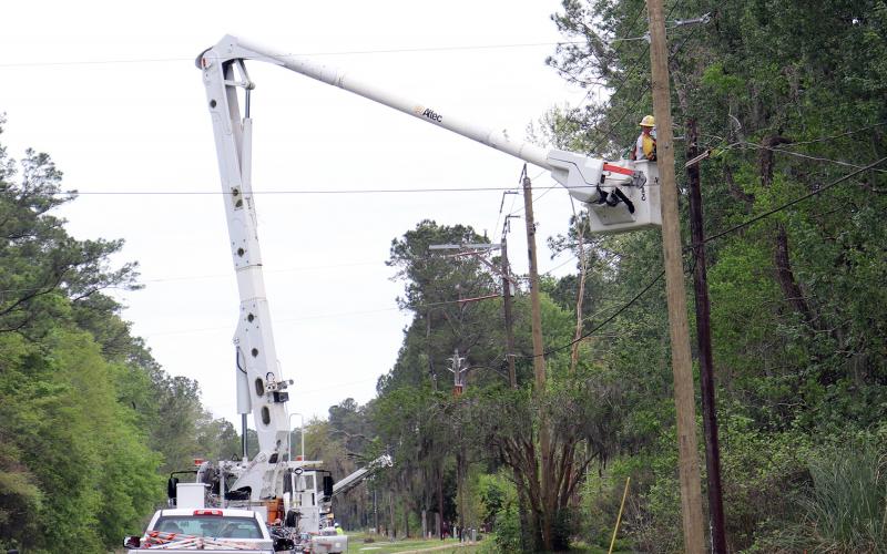 A crew works to replace poles along Lem Turner Road in Callahan March 29.