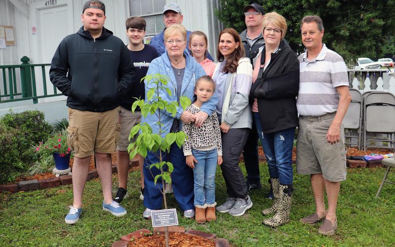The family of West Nassau Historical Society co-founder Jan Johannes gathers around a dogwood tree planted in his memory during the society’s 16th annual Railroad Day Festival April 17. 