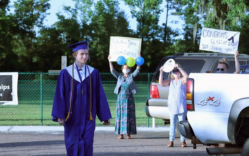 Sonshine Christian Academy held commencement at Crossroads Family Worship Center May 17. Around 20 people attended the ceremony due to social distancing. Afterward, educators and friends held up congratulatory messages outside. 