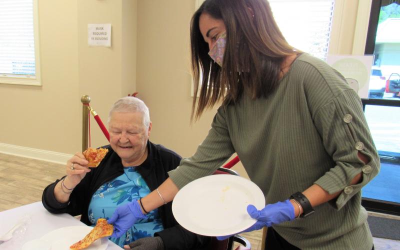 Nassau County Council on Aging’s dietician, Madeline Donovan, serves pizza to Gail Wagner.