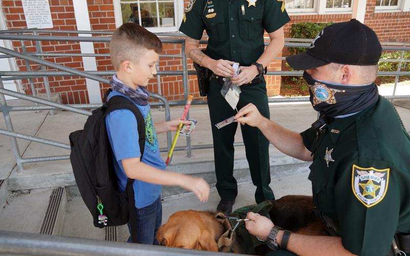 Callahan Elementary School students visit K-9 officers as they depart for spring break March 19. The Nassau County Sheriff’s Office bloodhounds visited the students, with their handlers giving out collectible K-9 cards.