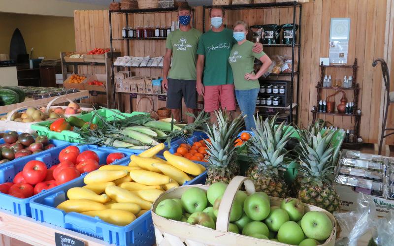 Family friend Bradley Brown helps Glenn and Jessie Bourquin supply fresh produce and farm products to Camden, Nassau, and Duval counties through their business, Jacksonville Fresh, which recently opened a store in Fernandina Beach. JULIA ROBERTS/NEWS-LEADER