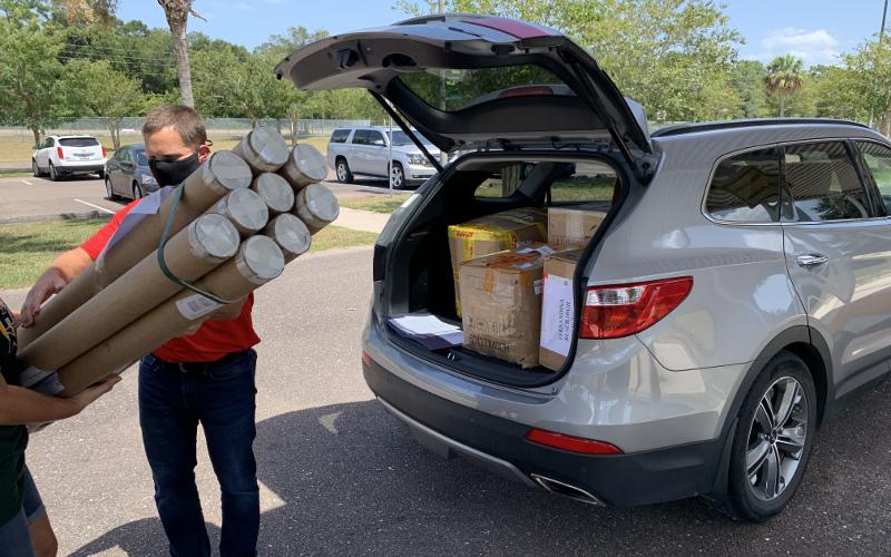 Jeffrey Brewer, STEM coordinator at Naval Submarine Base Kings Bay, Ga., unloads some of the thousands of dollars worth of equipment donated recently by the Navy to the Nassau County School District. SUBMITTED