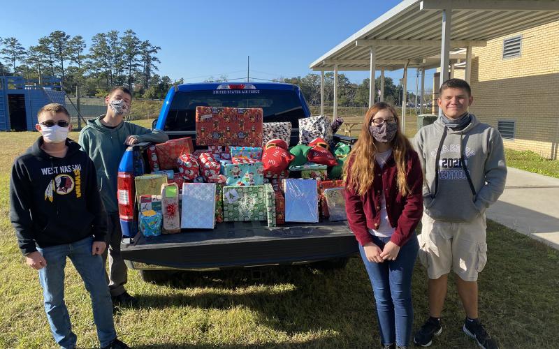 Air Force JROTC cadets display some of the toys they donated to Callahan Volunteer Fire Department’s annual giveaway. The station’s volunteers delivered the toys to children as they drove Santa and his elves through town.