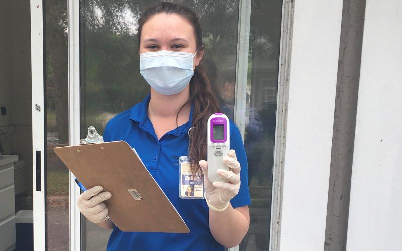 Osprey Village staff member Caitlyn Lee screens people coming into the community as part of measures that have helped the community maintain zero positive coronavirus tests of staff and residents. SUBMITTED PHOTO