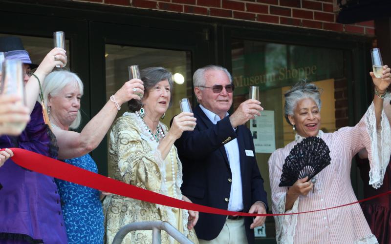 Amelia Island Museum of History employees and board members toast the grand reopening of the museum. 