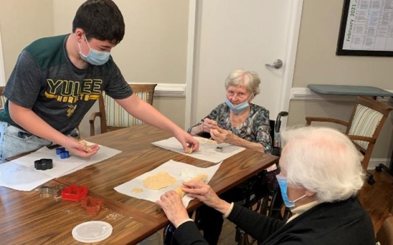Yulee Middle’s Asher Conway spends time with assisted living residents at Osprey Village.