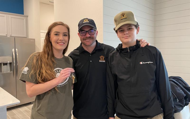 U.S. Marine Sgt. Bradley Thomas, and his wife, Kori Thomas, and son, Landon Thomas, celebrate the mortgage-free home they received from Lennar.