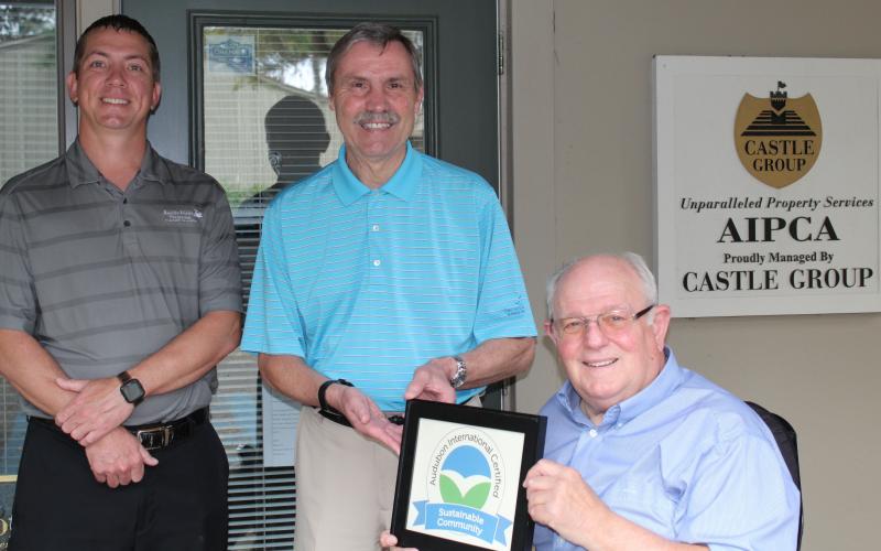 Amelia Island Plantation Community Association Director of Facilities and Maintenance Kenny Walczak, from left, AIPCA Executive Director Tim Digby and Amelia Island Plantation Foundation President Bob Schmonsees pose with the AIP’s Audubon International Sustainable Community Certificate.